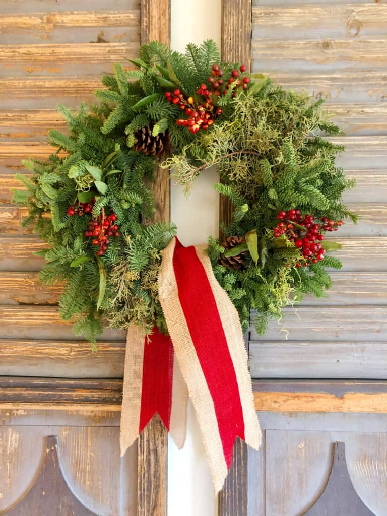 fresh christmas wreath on vintage shutters