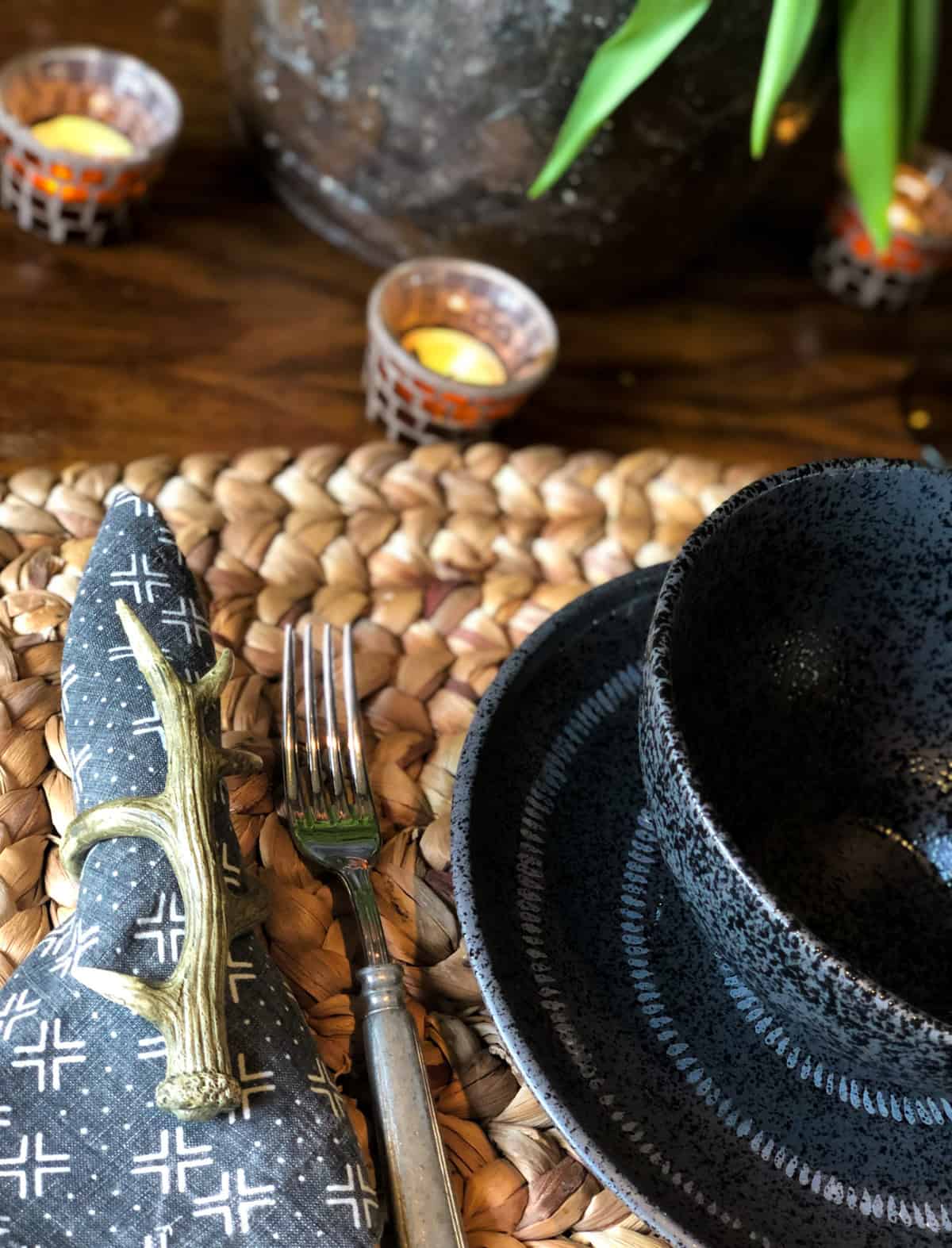 black place setting with ethnic napkin