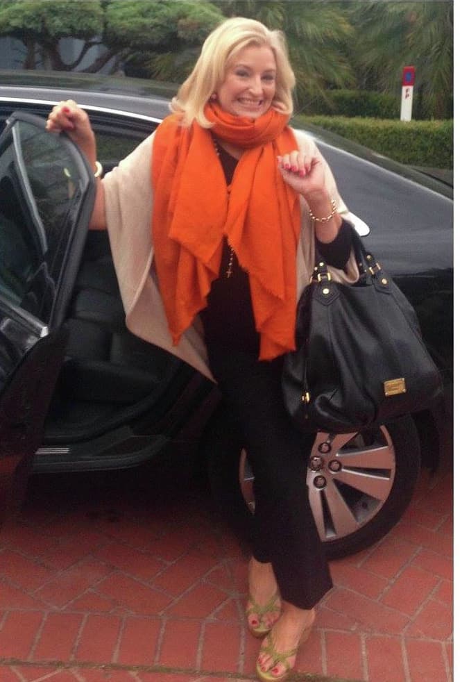 sarah foster in black with orange scarf