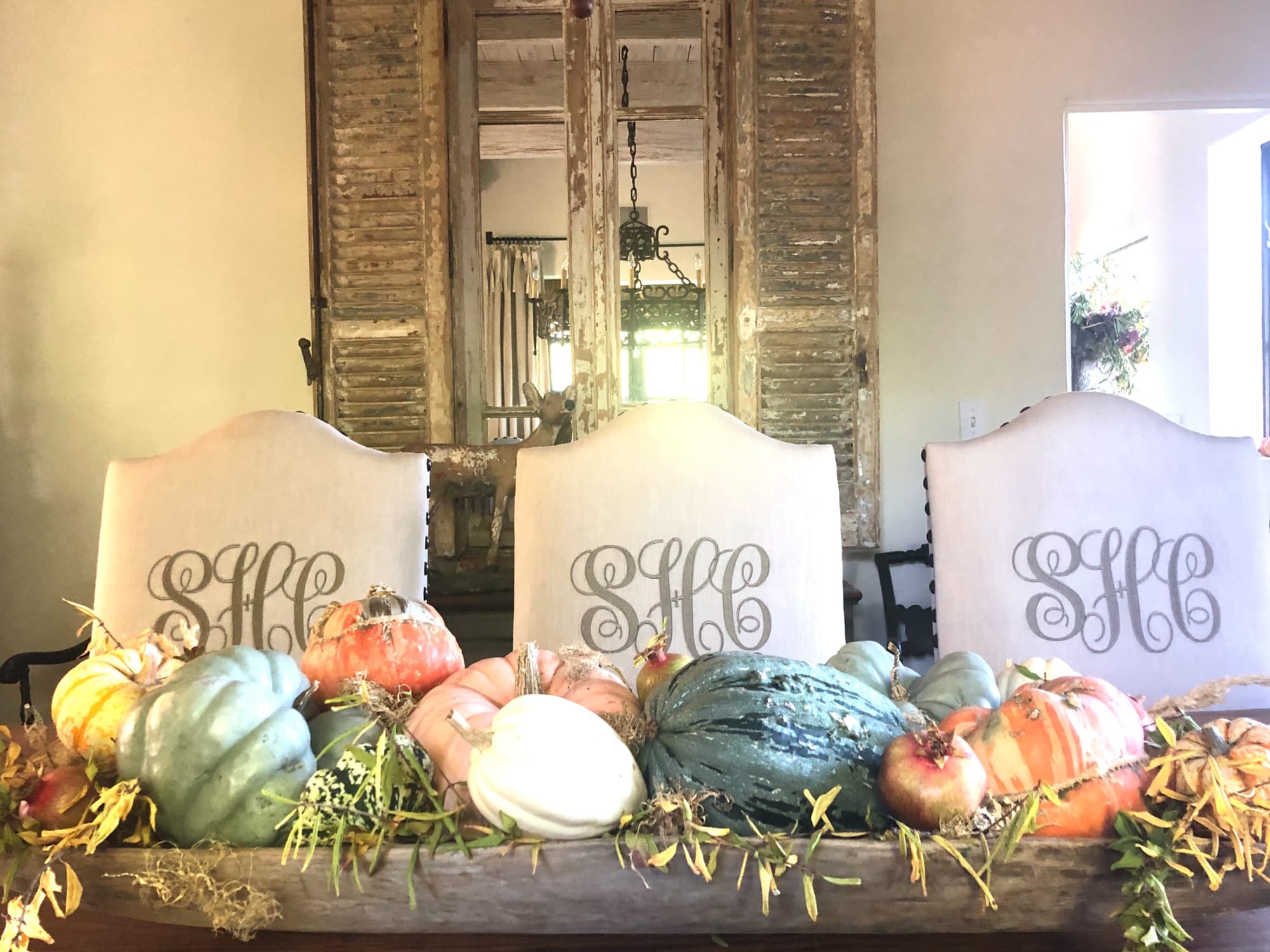antique dowl bowl with pumpkins and monogram chairs