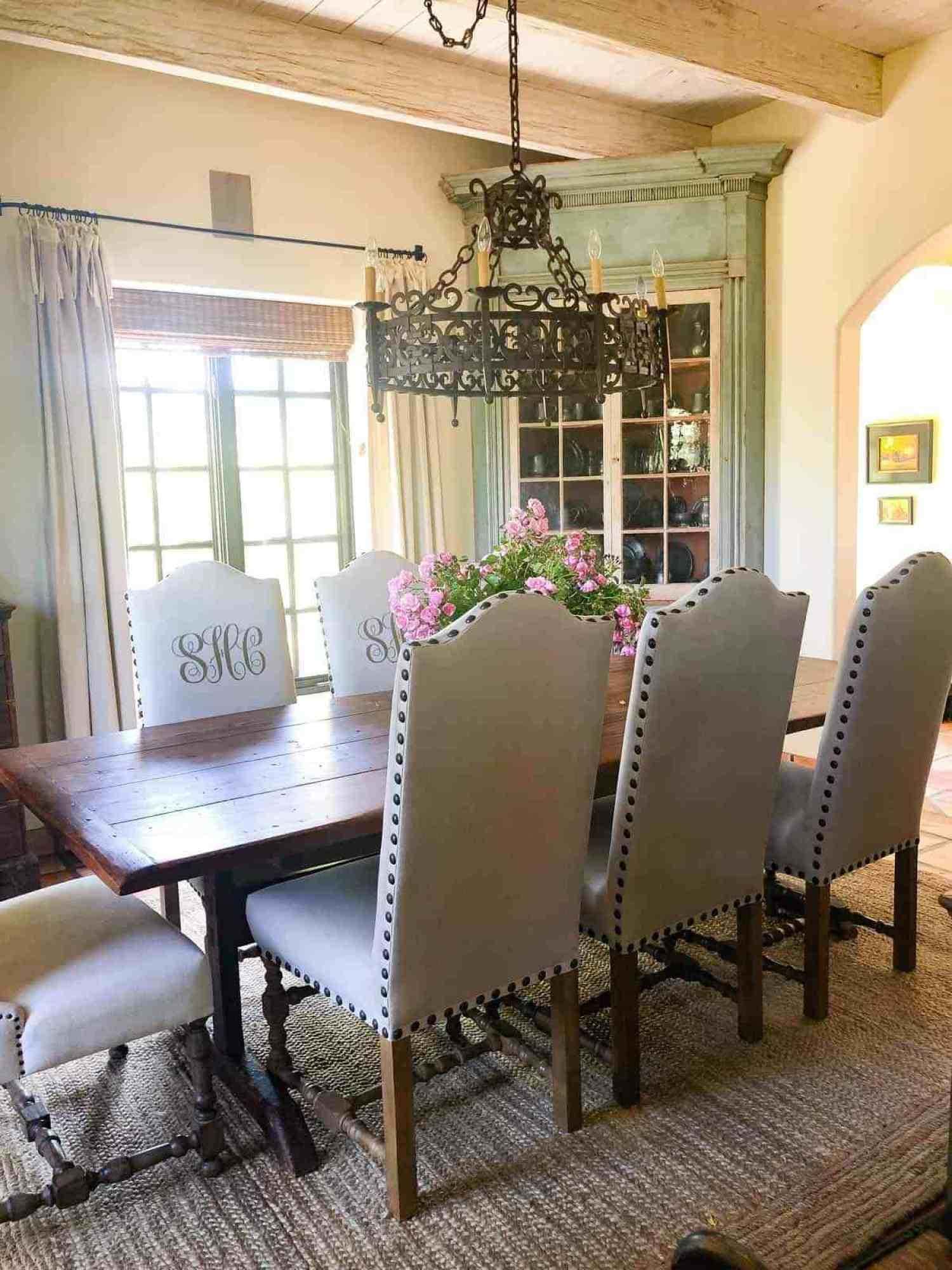 dining room with antiques and monogrammed chairs