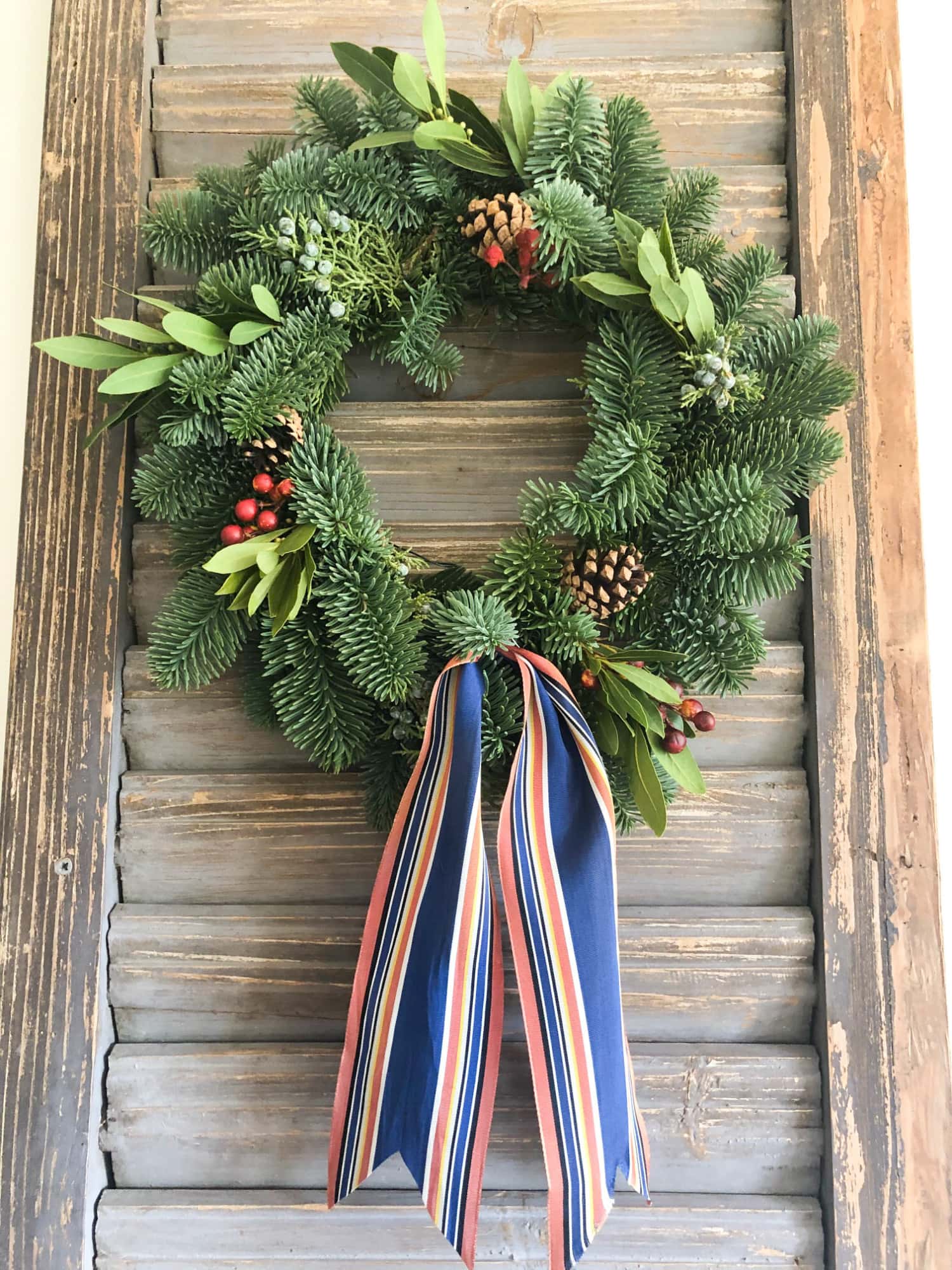 trader joe's wreath on old shutter with vintage ribbon