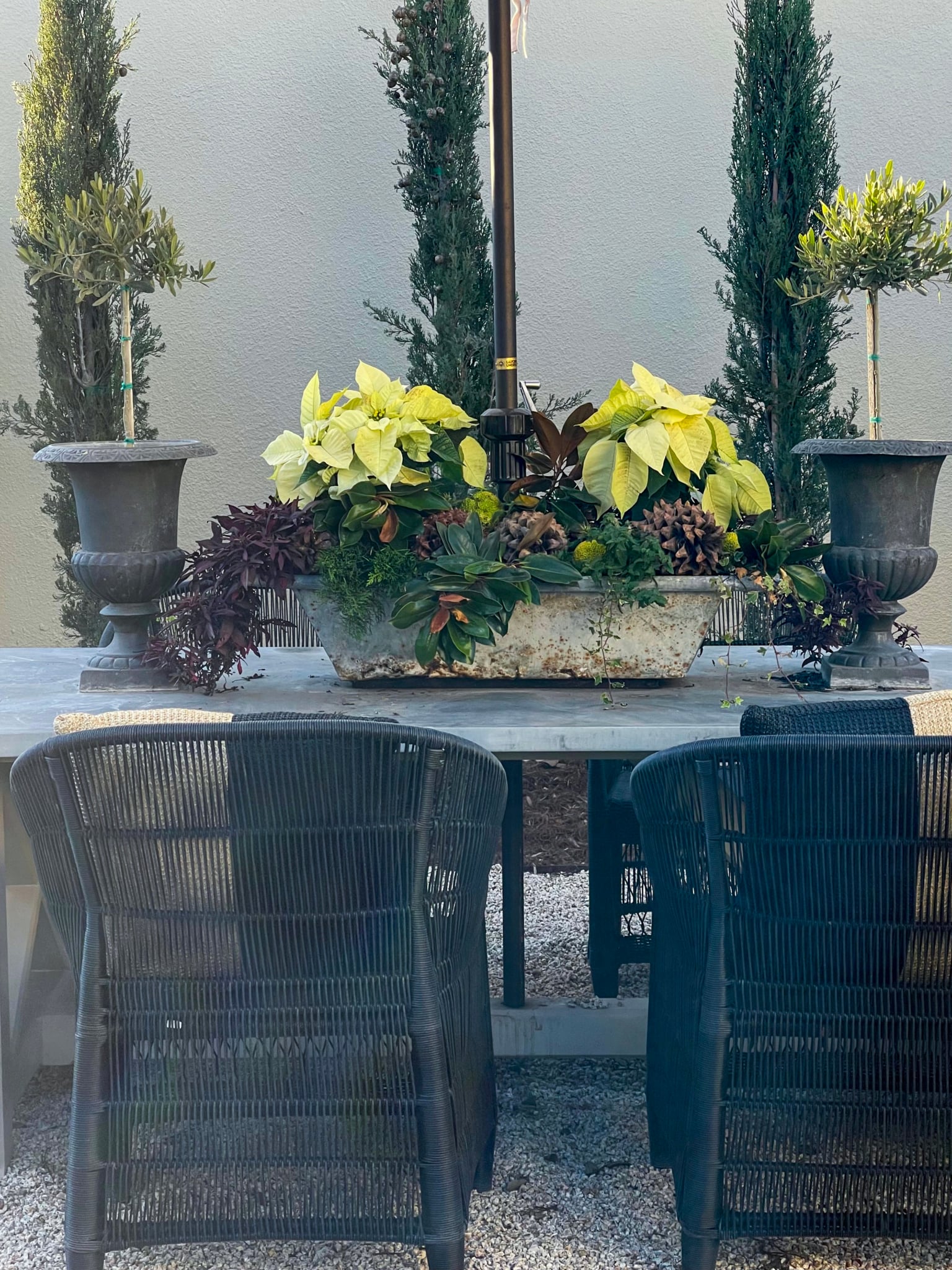 table and chairs with christmas arrangement back yard