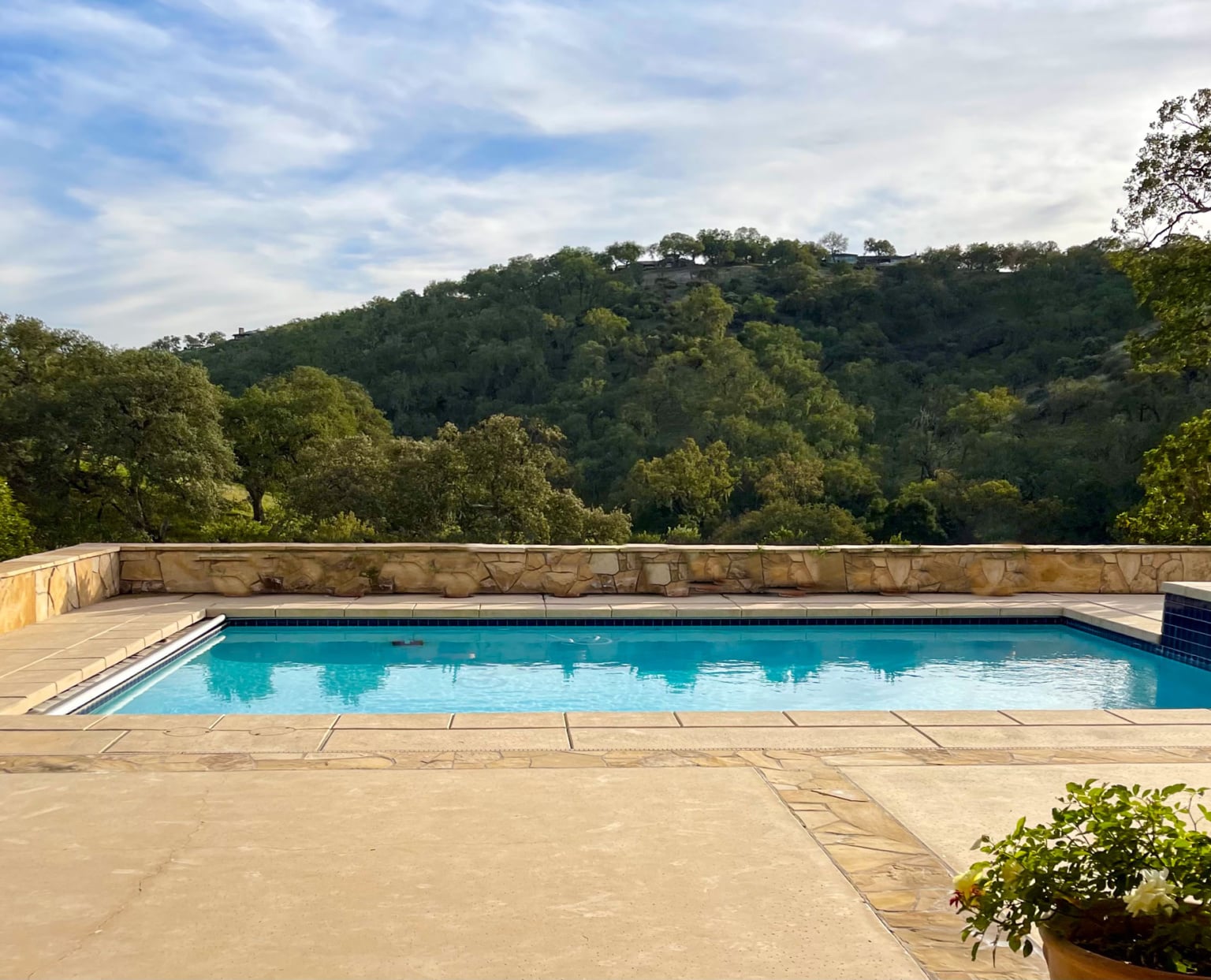 The kitchen faces the beautiful pool area which incorporates more of the beautiful stone that is scattered about the property.