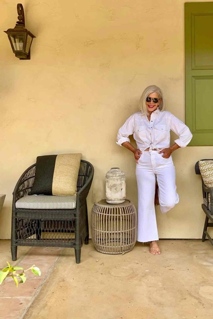 Silver haired Cindy Hattersley in white denim shirt and white jeans