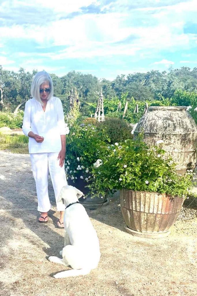woman with gray hair in whiet with white lab