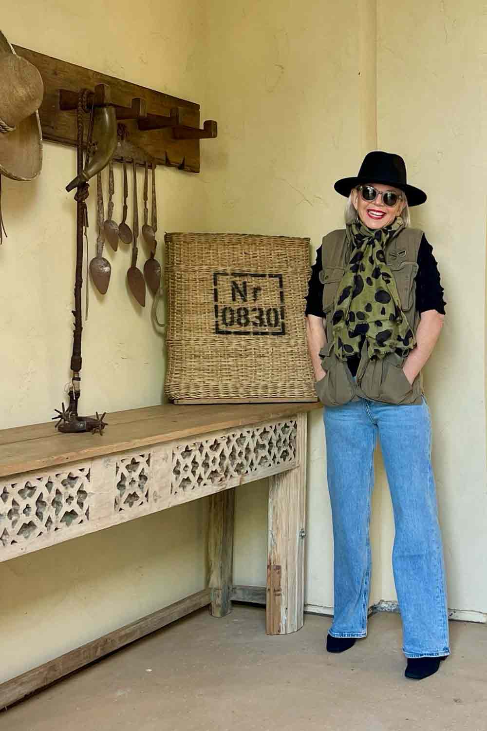 Utility vest with jeans, black turtleneck hat, boots and lepard scarf
