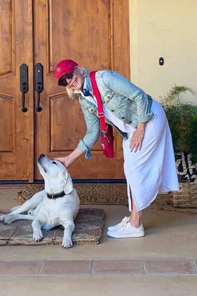 cindy hattersley in jean jacket & shirtdress with her lab Scout