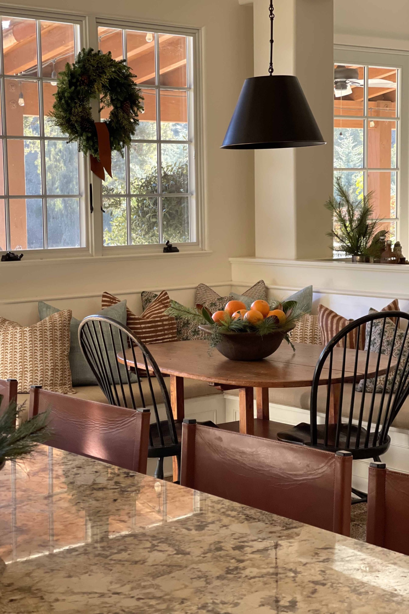 banquette with bowl of oranges 
