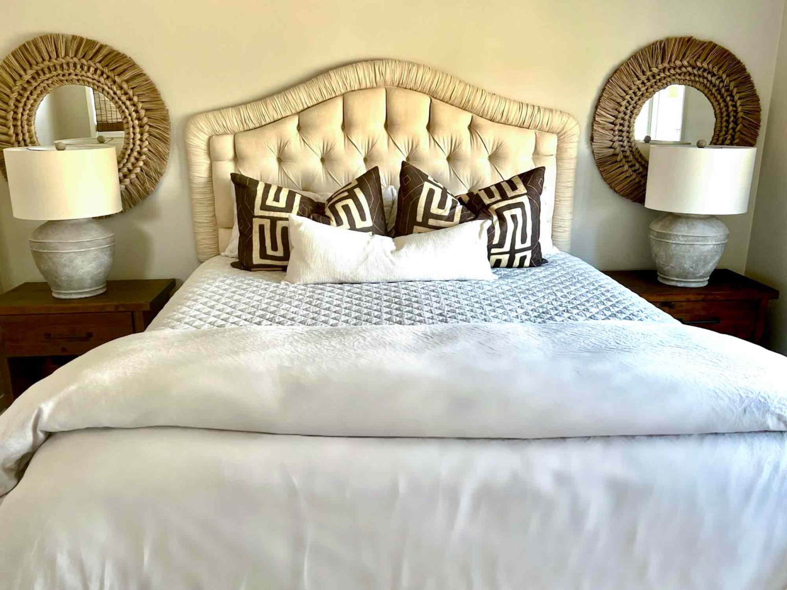 guest bedroom with headborad and mirrors