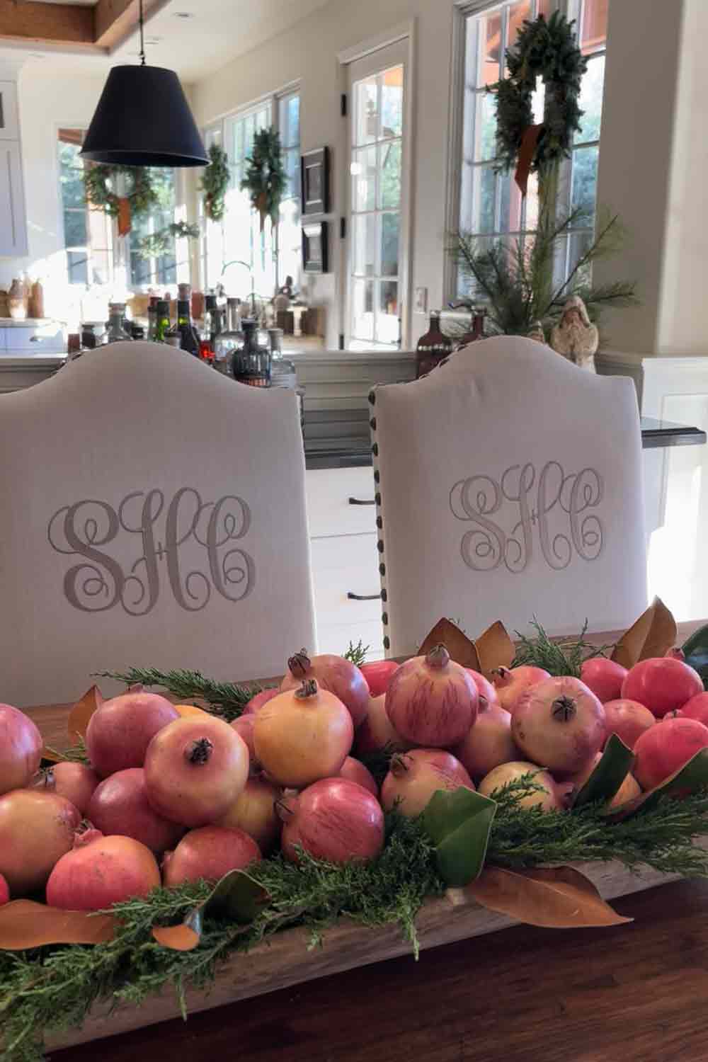 Monogrammed chairs with bowl of pomegranetes