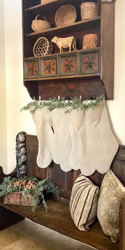 Linen Christmas stockings hanging above and antique bench