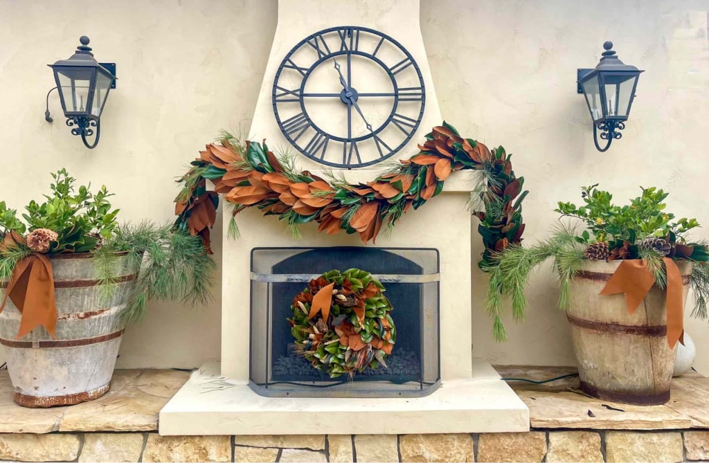 Outdoor Fireplace decorated with Magnolia wreath and garland