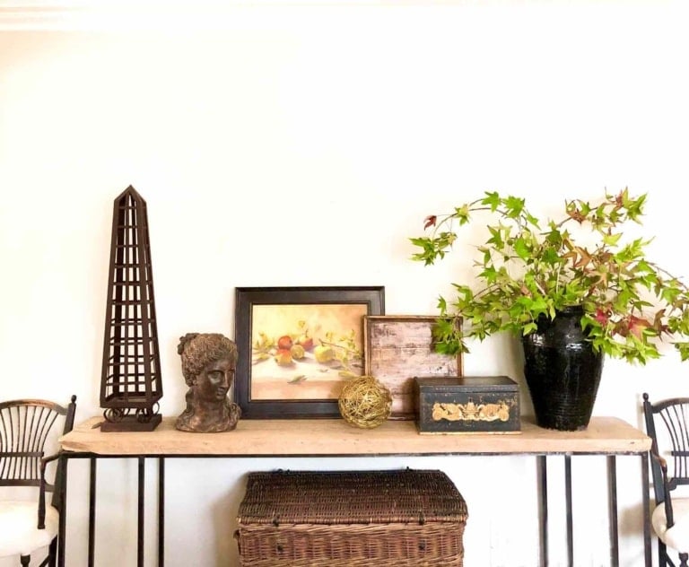 Console table styled with art, and vintage accessories