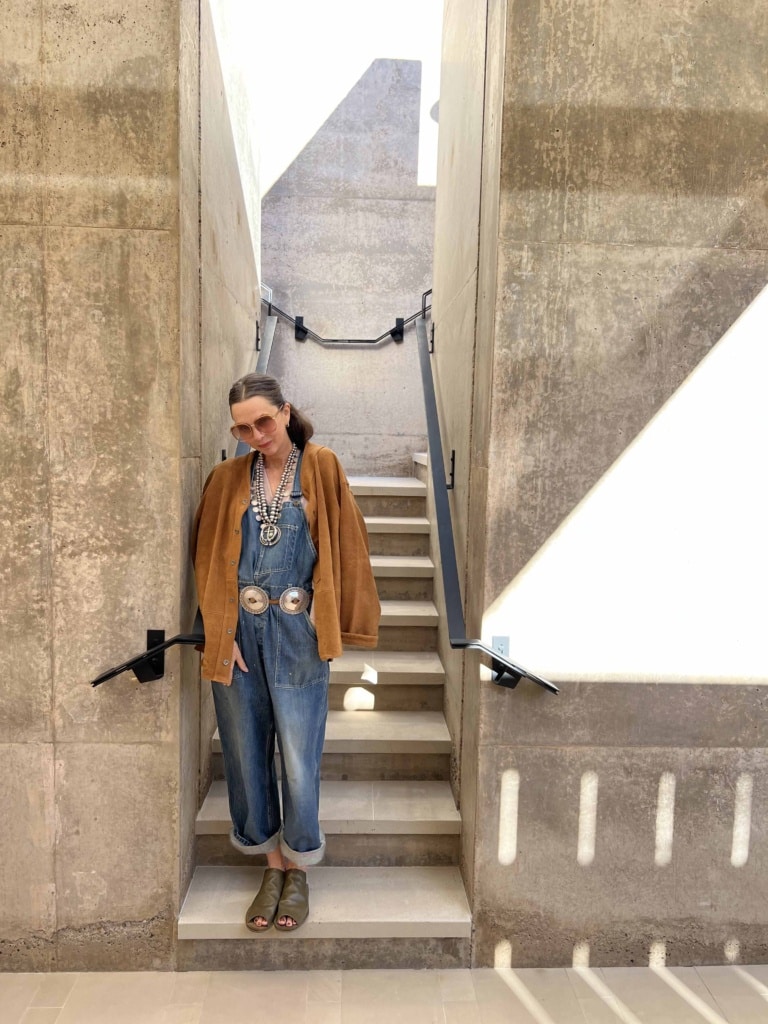 jill sharp weeks in overalls at foot of stairs