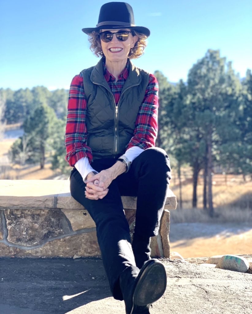 Meet a Dynamic Woman Over 60 Making a Difference Jeanette Heitz in jeans plaid shirt and vest