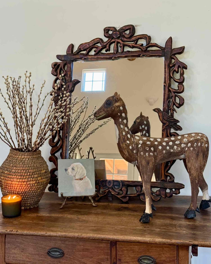 table vignette with folk art deer
