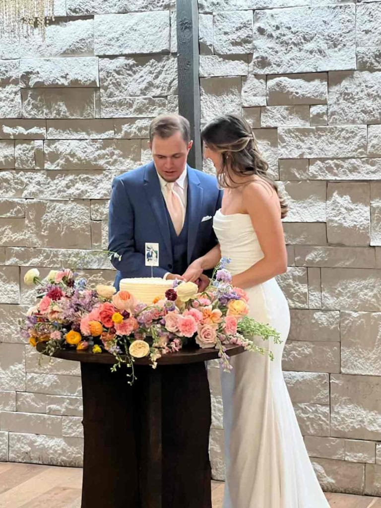 bride and groom cutting their cake