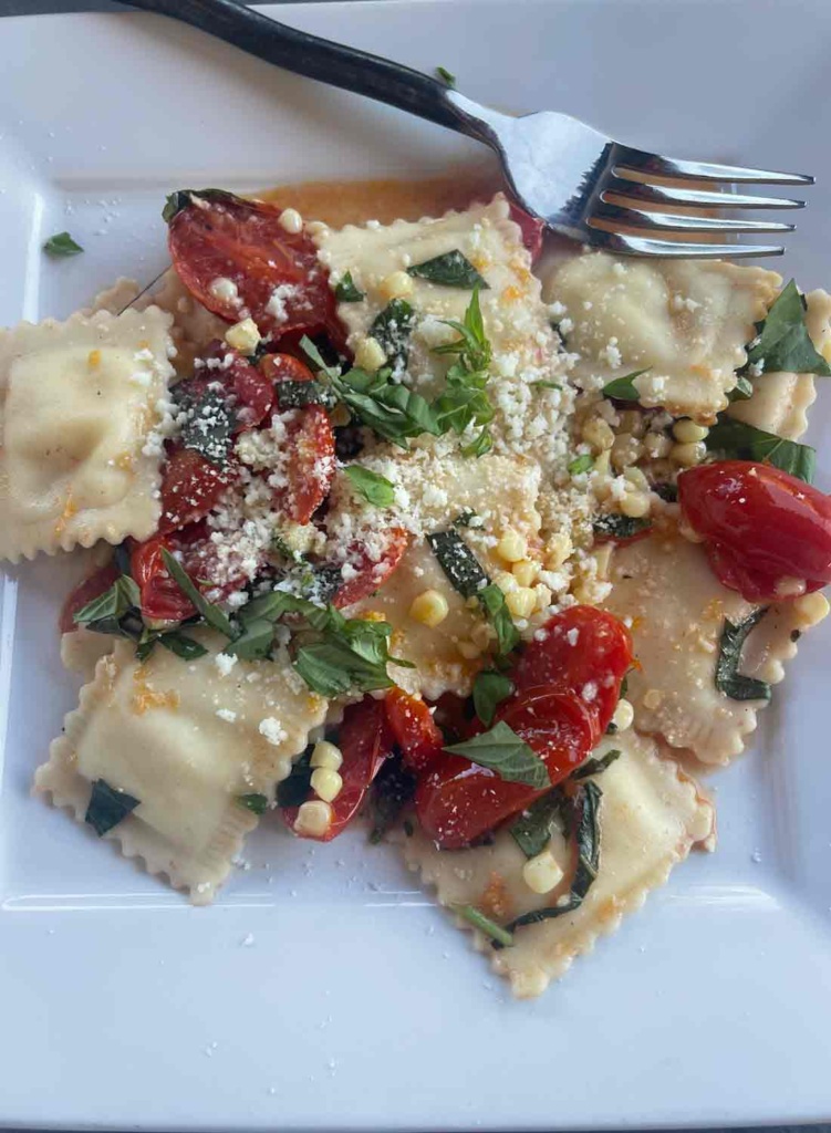 fresh etto ravioli with corn and tomatoes
