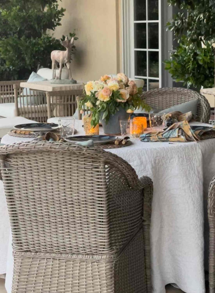 outdoor dining table with flowers and votives