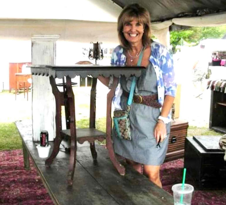 Martha Foss and her antique table from Brimfield