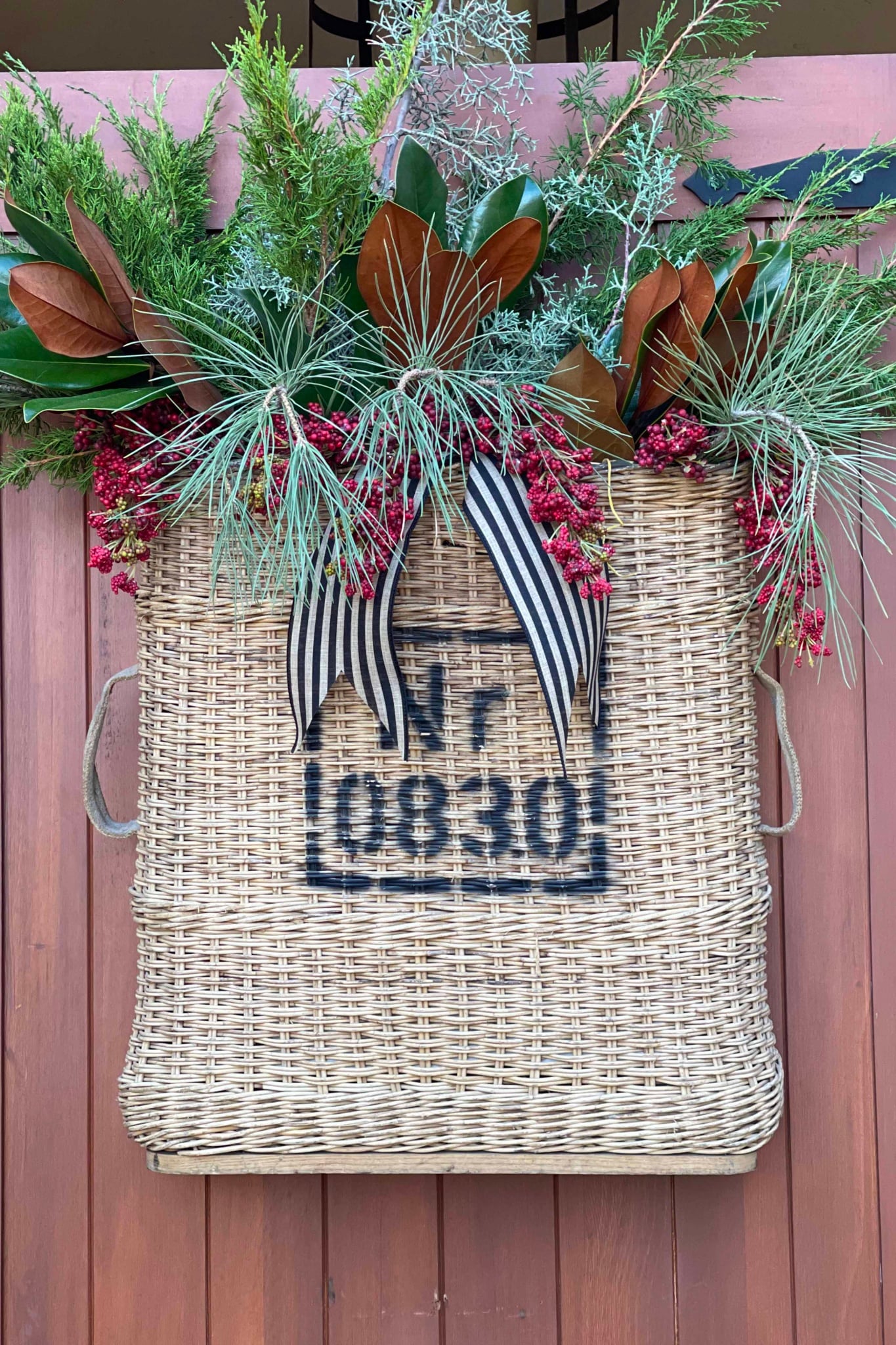 Vintage Artillary Basket filled with greens, magnolia and faux berries-Cindy Hattersley Design