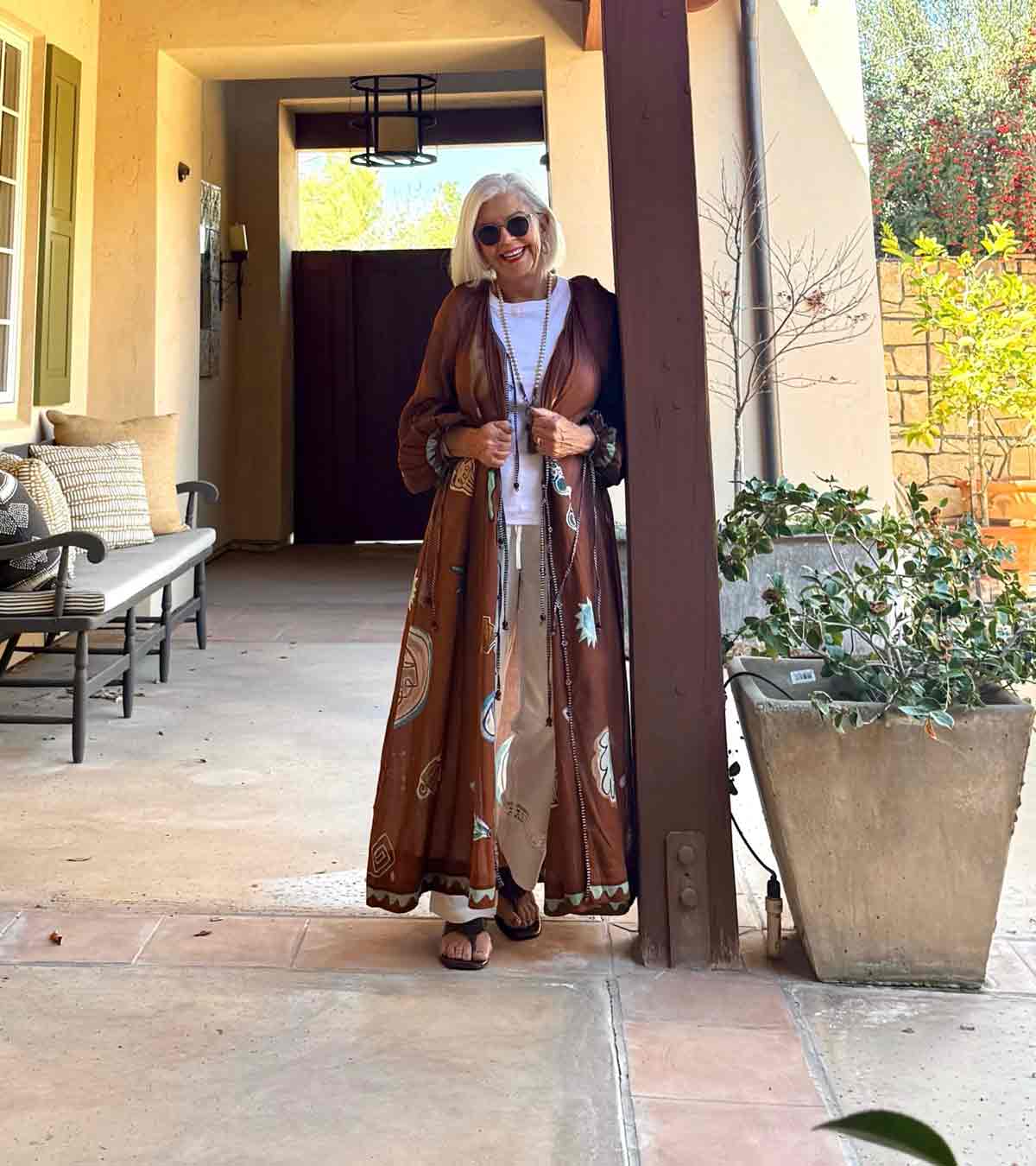 cindy hattersley in white pants, tee and brown Alemais kaftan