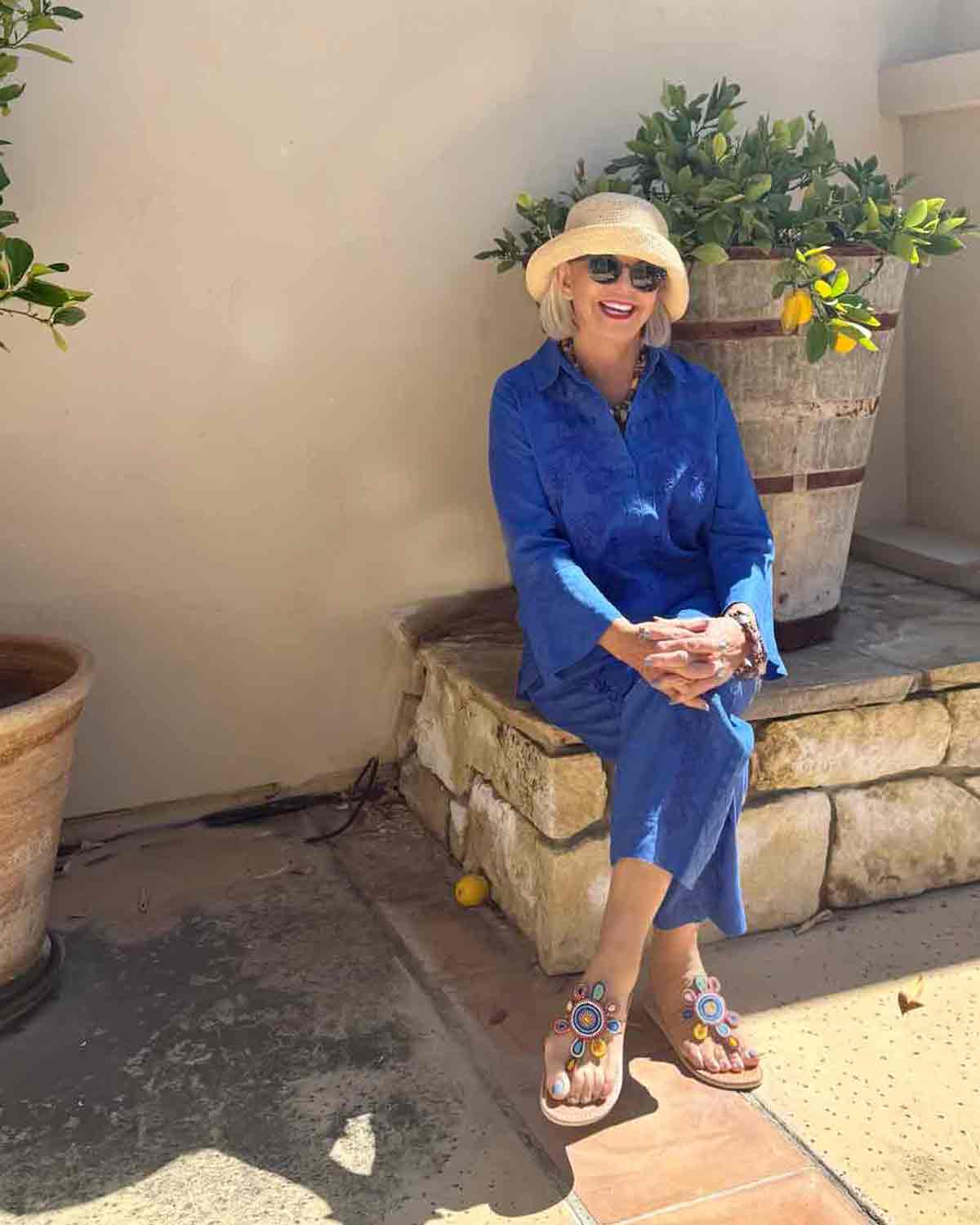 Cindy Hattersley in blue matching set from Johnny Was, Laid Back London sandals, and Helen Kaminski hat best vacation outfits for women over 60
