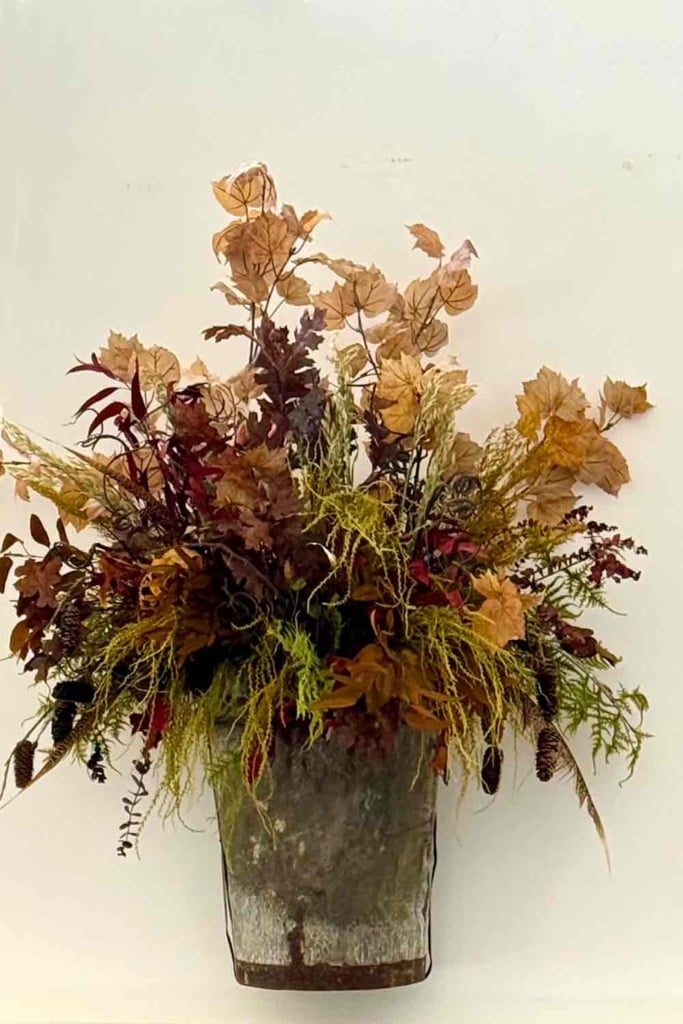 Autumn arrangement in vintage grape hotte