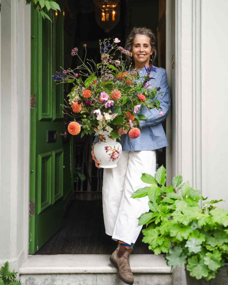 Garden Designer Butter Wakefield with bouquet at her door