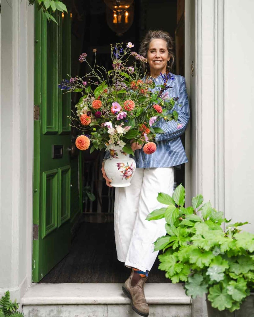Garden Designer Butter Wakefield with bouquet at her door