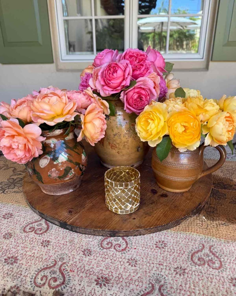Collected tablescape garden roses in antique vessels cindy hattersley