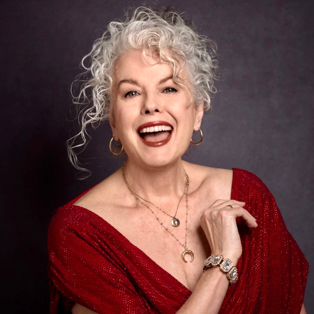 Kerry-Lou Henson, silver hair expert and founder of Silver Style Studio in red