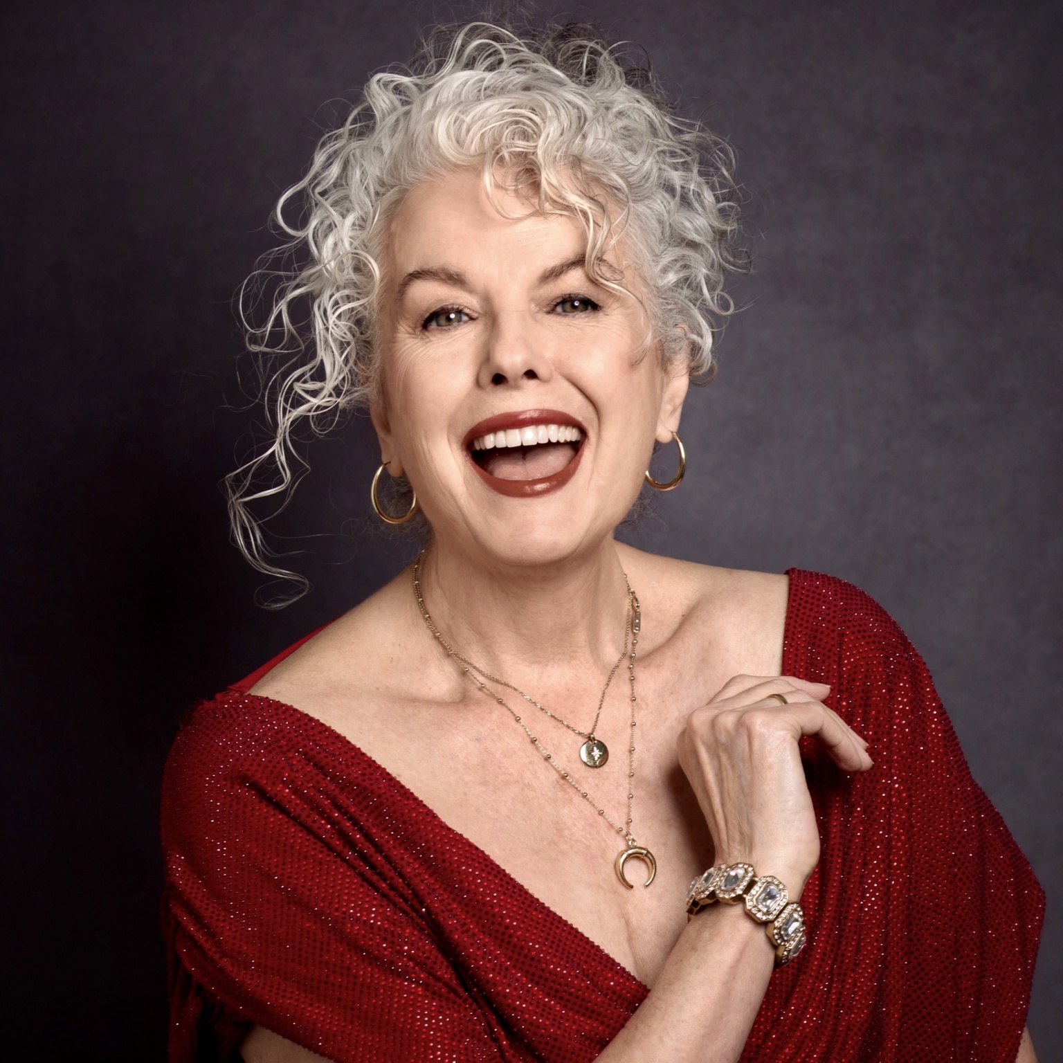 Kerry-Lou Henson, silver hair expert and founder of Silver Style Studio in red