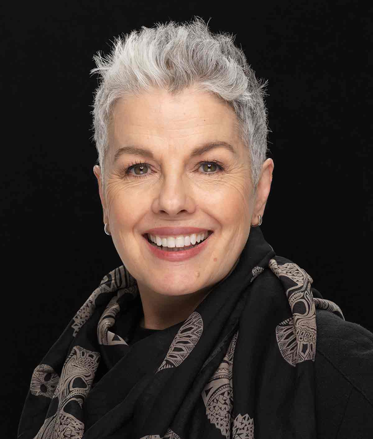 Kerry-Lou Henson, silver hair expert and founder of Silver Style Studio with pixie cut