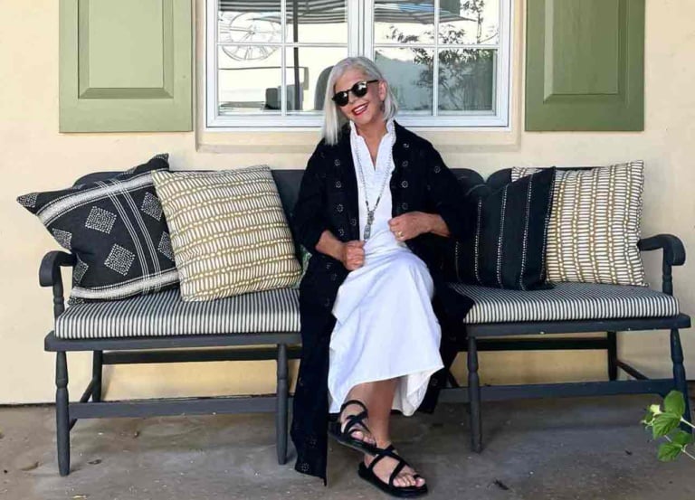 White dress styled with black eyelet duster-style over 60