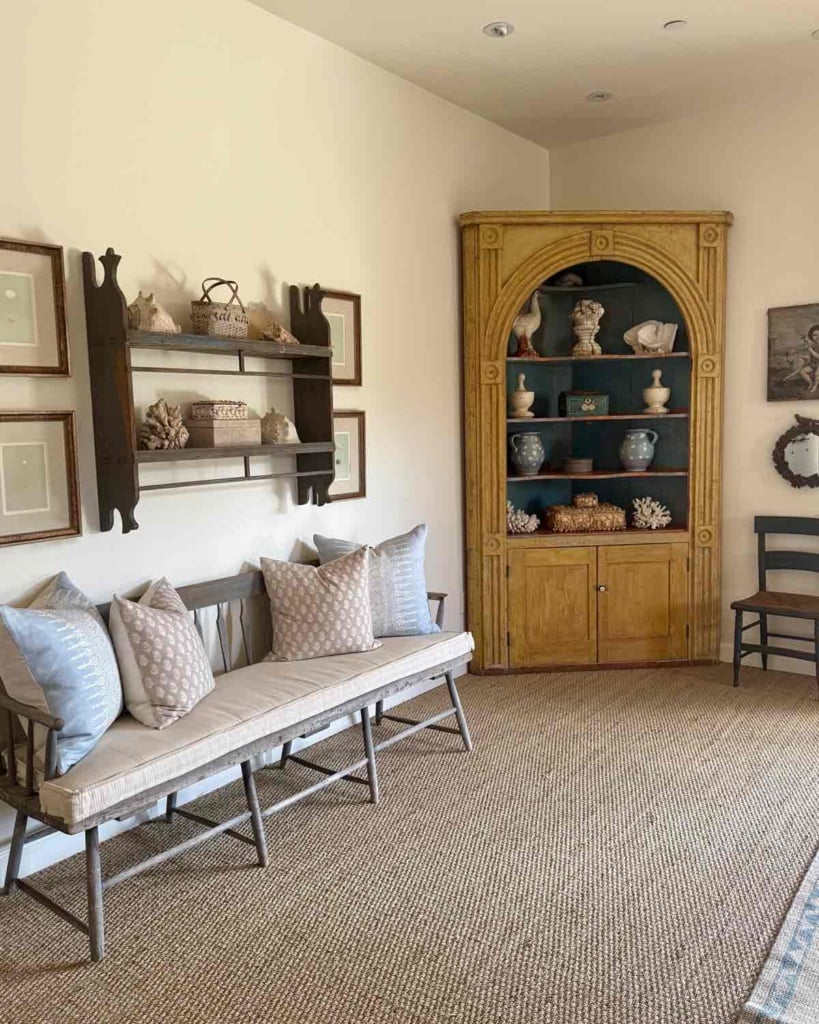 cindy hatterslry primary bedroom with antique bench & corner cupboard