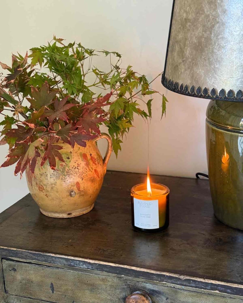 Flamingo Estate Candle with Fall Leaves on Nightstand